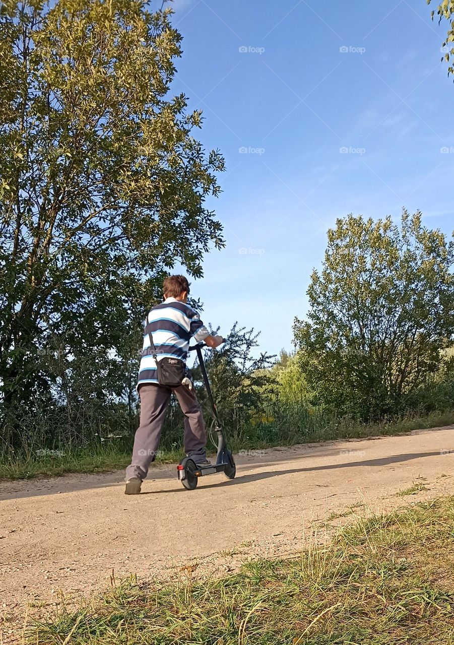 boy on a electric scooter, summer time