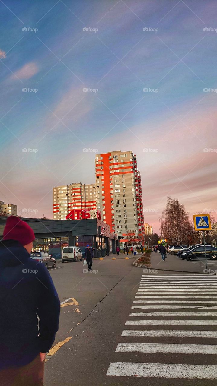 autumn city sunset on the background of a large apartment building