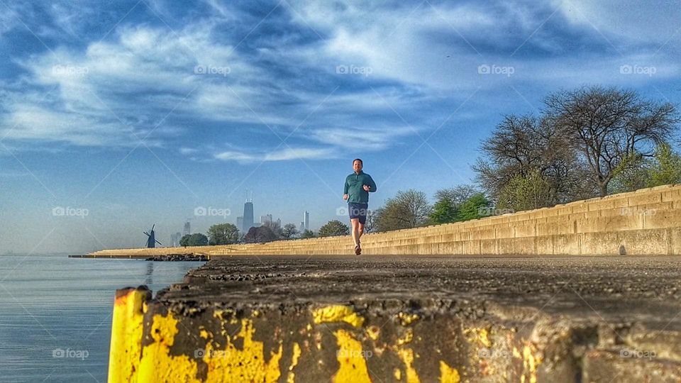 jogger on boardwalk of lake Michigan and Chicago