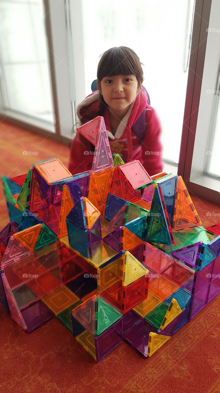 Portrait of a girl with magnetic play set