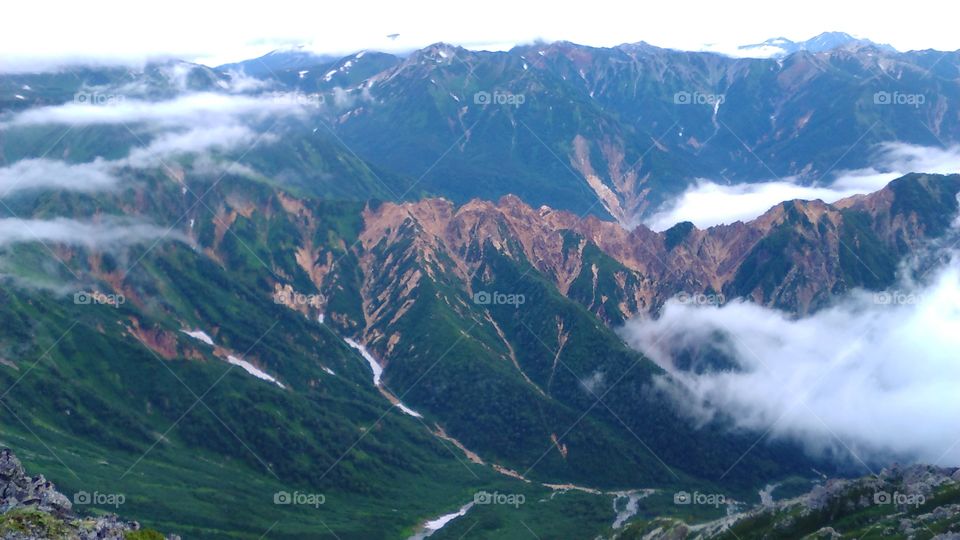 Stunning views of the lush green mountains of the Japanese Alps in summertime.