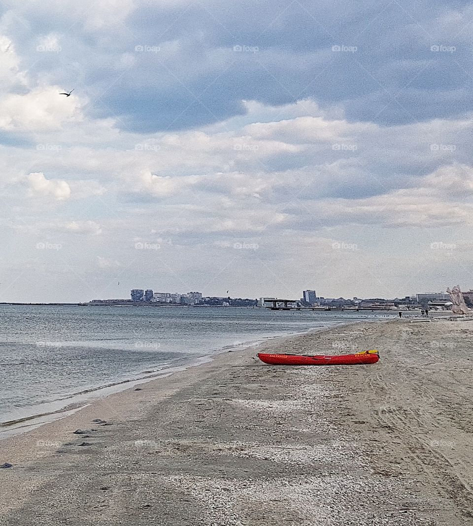 Red boat on the beach.