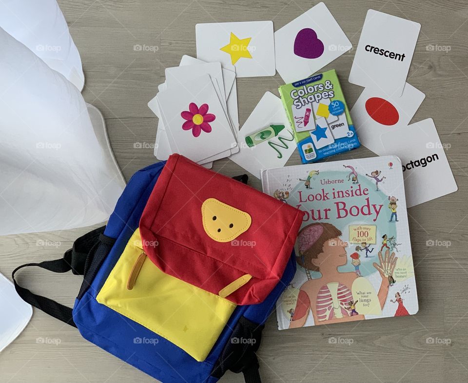 Children school bag and books and flash cards for learning at the comfort of home