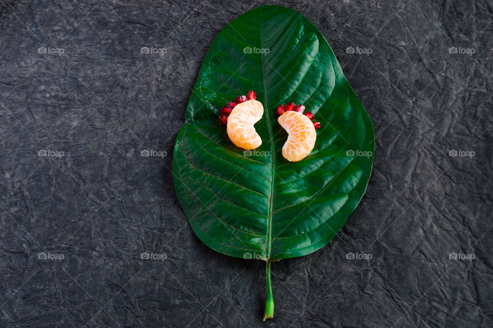 Little orange feets with pomegranate toes😍. Imagination of fetus using leaf and fruits.