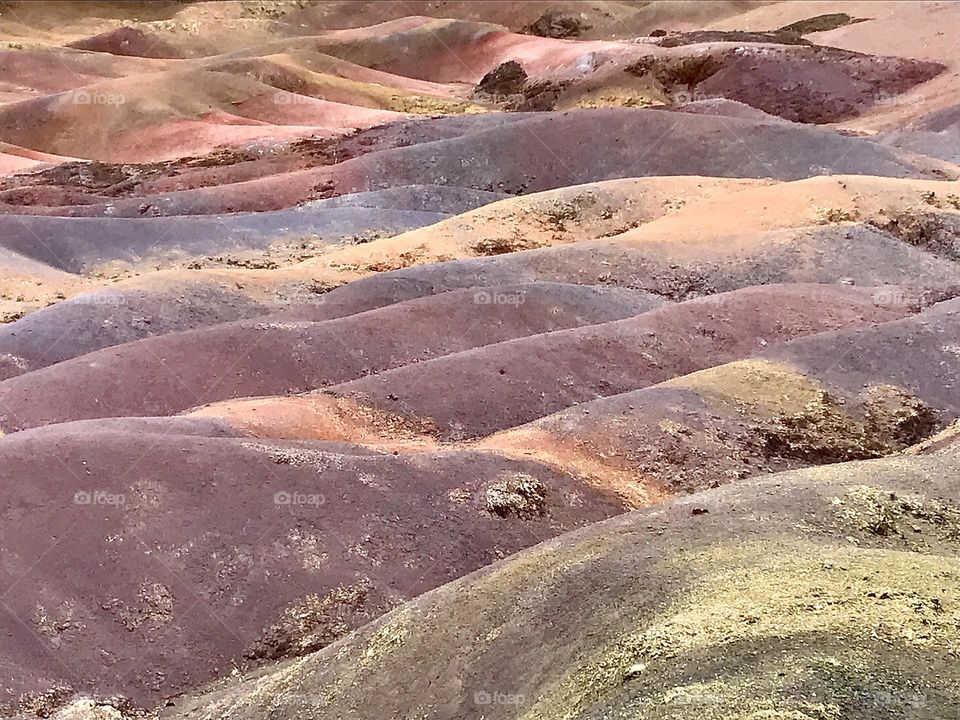 Chamarel seven coloured earth, Mauritius. Naturally occurring phenomenon. 7 distinct colours can be seen, approximately red, brown, violet, green, blue, purple and yellow. I’ve enhanced the photo only slightly to bring out the colours. 