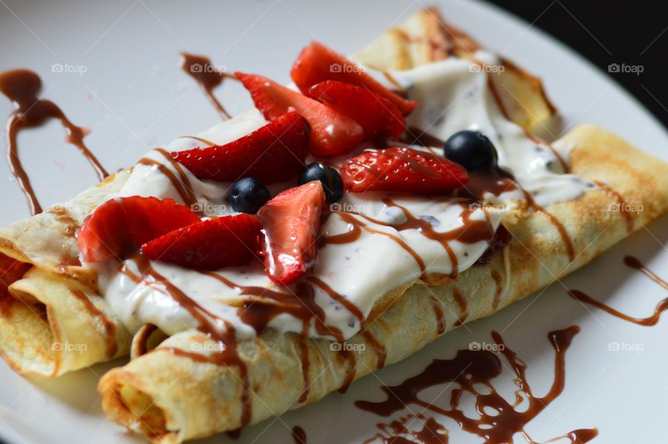 Pancakes with fresh fruits on plate