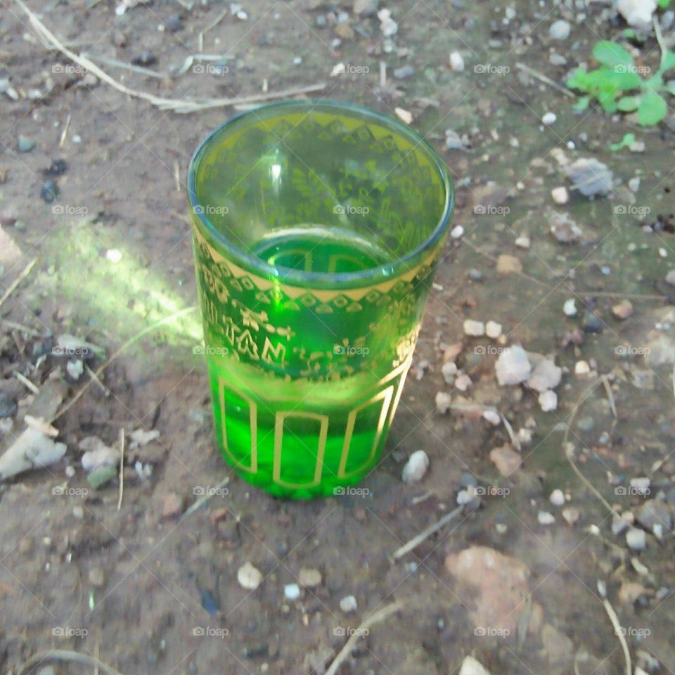 Green cup on ground.