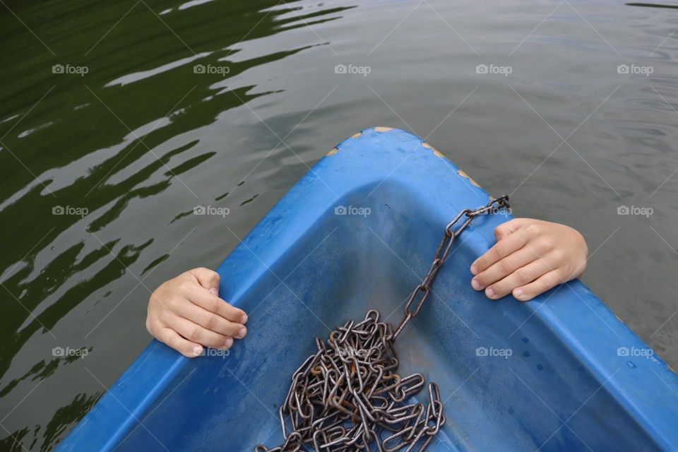 Blue boat front with hanging hands