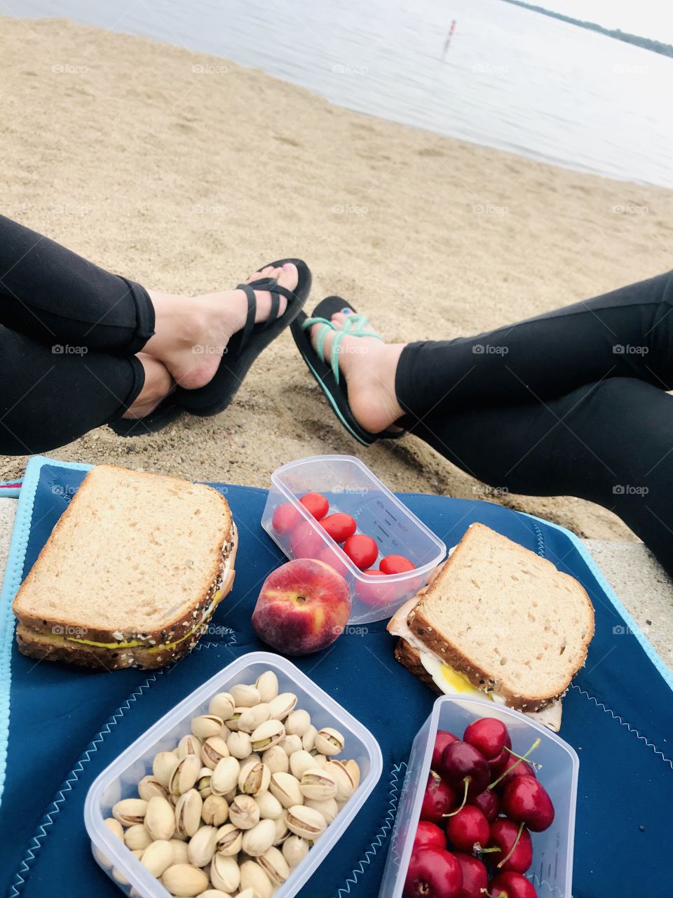 This is how we like to eat...sitting at the beach with our sandwiches, tomatoes, cherries, pistachios, and a peach! So relaxing!! 