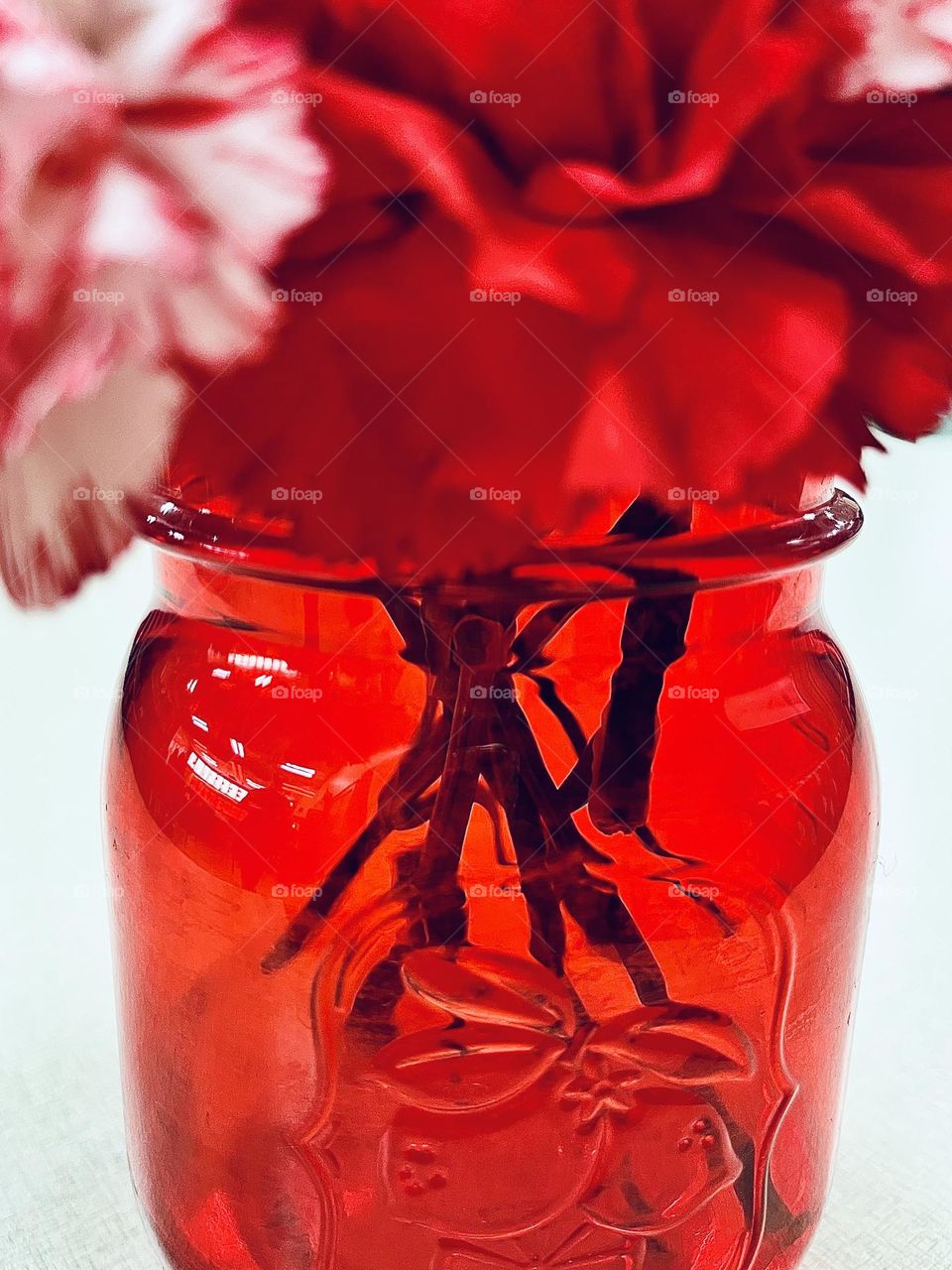 Red Flowers in Red Mason Jar Vase