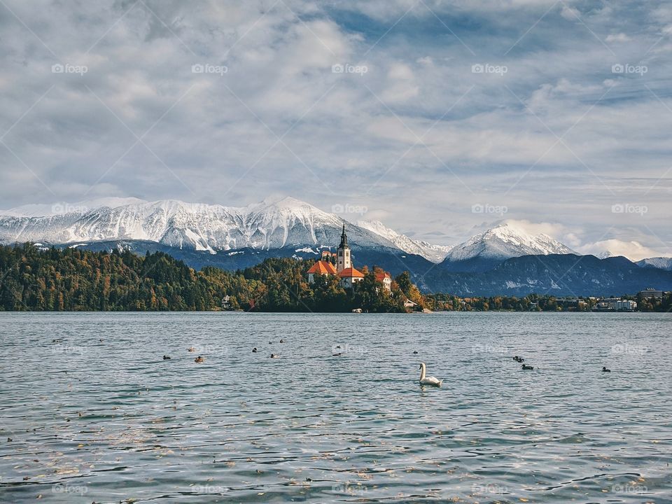 View of the snow-capped mountain peaks against the backdrop of Lake Bled.