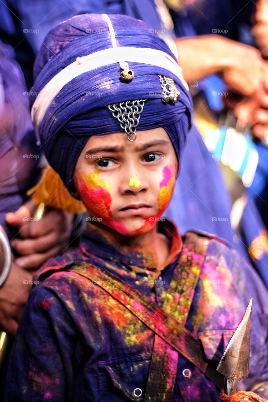 Sikh boy with holi colors on his face