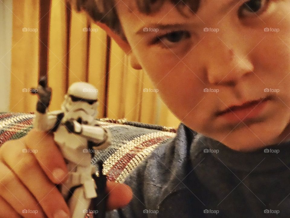 Boy Playing With Star Wars Toy
