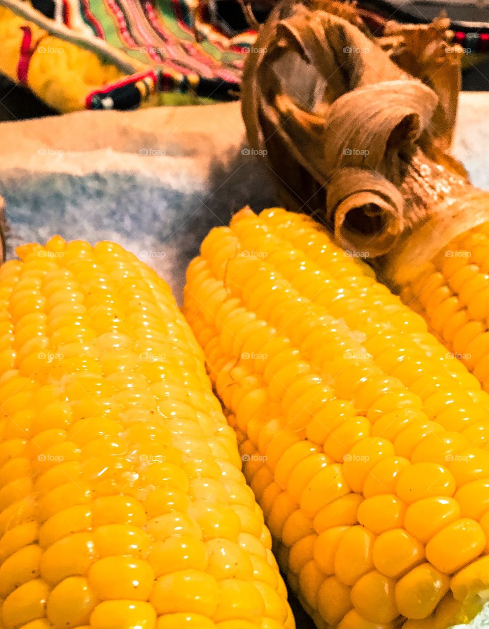 Close-up image suitable for background roasted corn on the cob corn cobs with husks  buttery delicious 