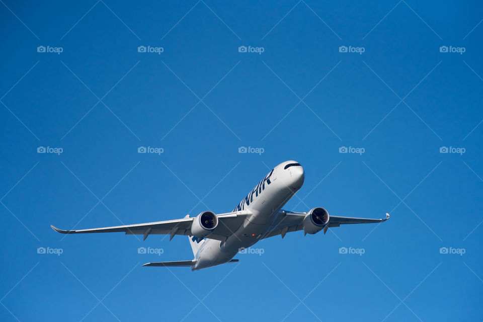 Helsinki, Finland - 9 June 2017: Finnair Airbus A350 XWB airliner flying on blue sky over Helsinki at the Kaivopuisto Air Show 2017