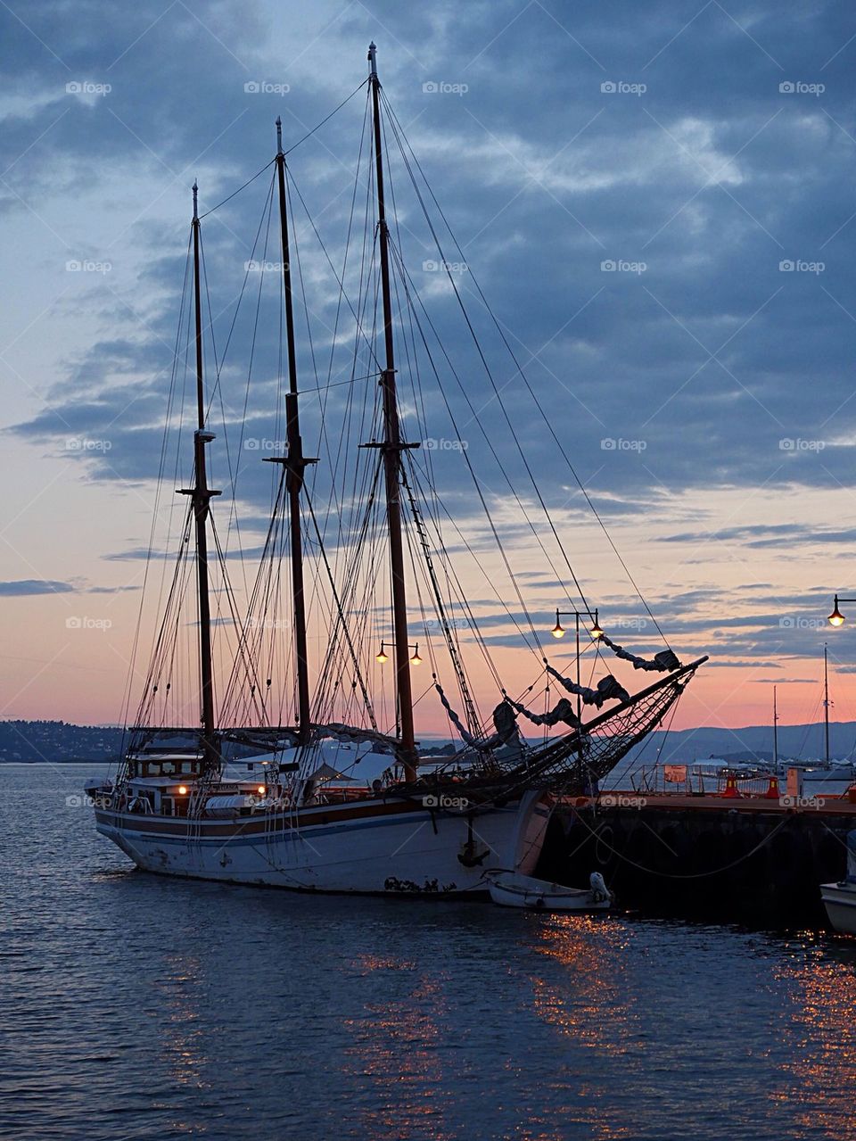 Tall ship in harbour at sunset