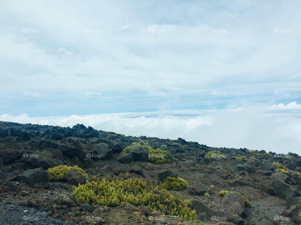 Above clouds top of the volcano 