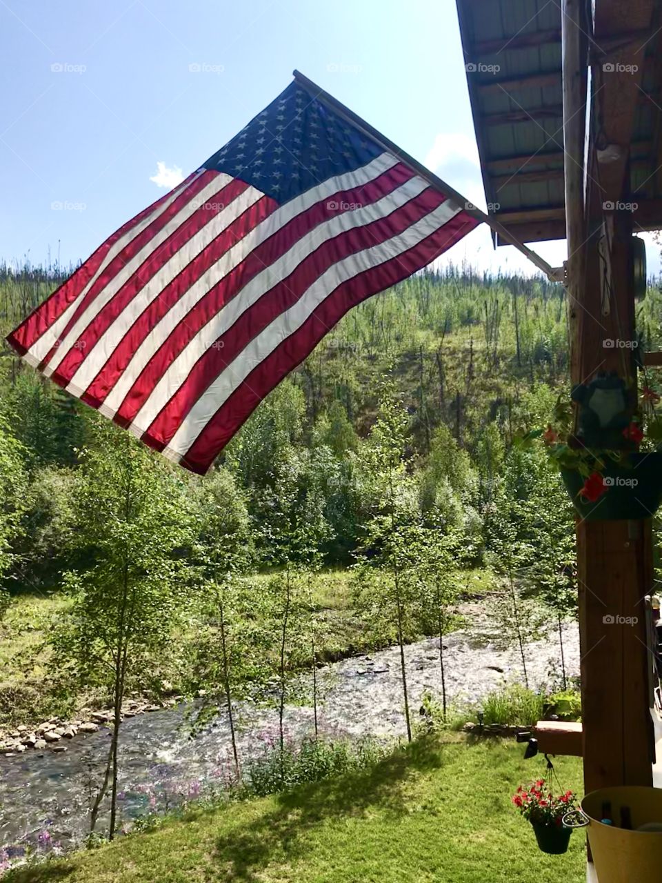 Red, White and Blue proudly at cabin by the river