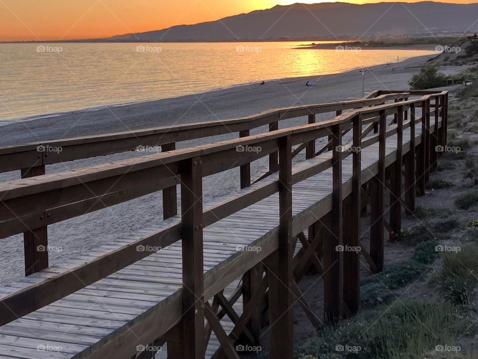Sunset on footpath near a beach