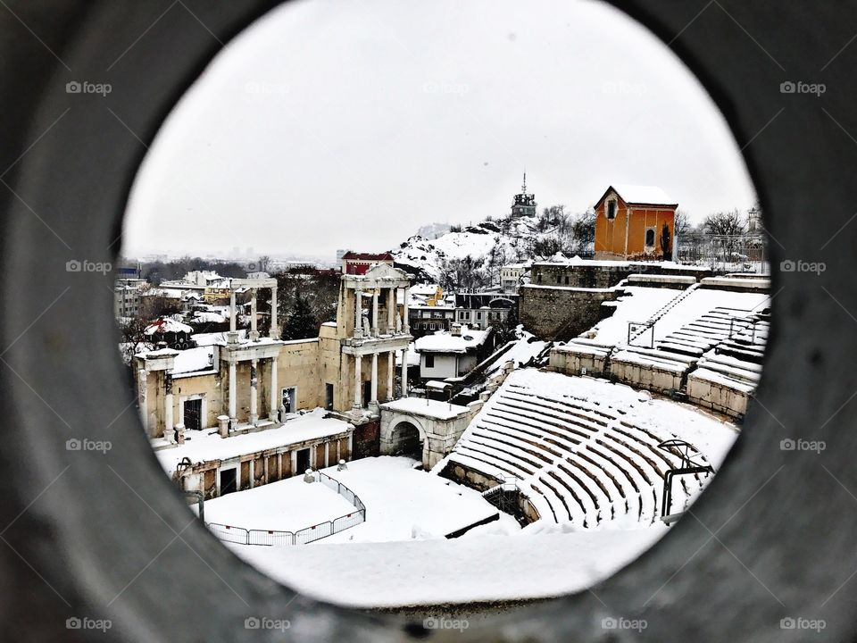 Old amphitheater in the city with snow
