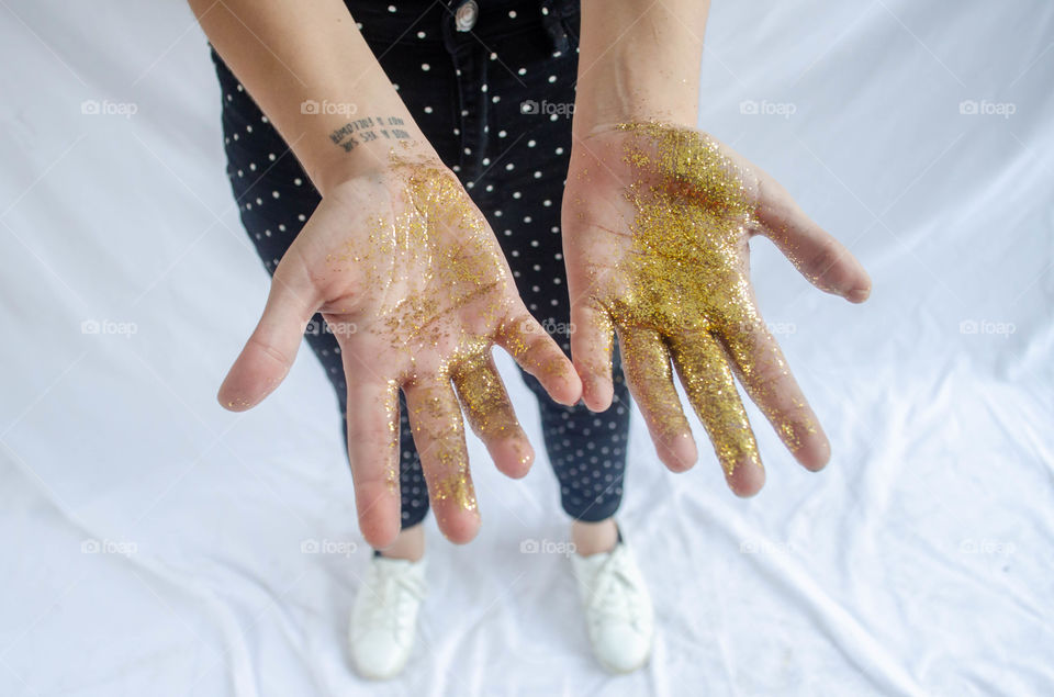 Glitter on a girl’s hands symbolizing happiness and her love for other people. Taken for pride to show how beautiful lgbt+ people are inside.