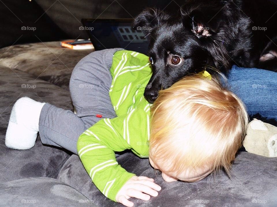 Cuddling baby and dog