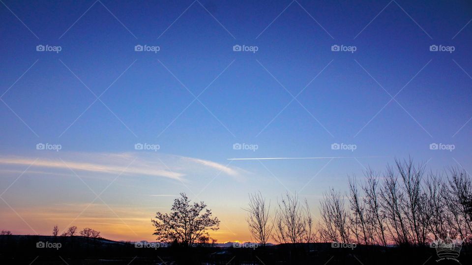Beautiful landscape with a blue sky and orange sunset.