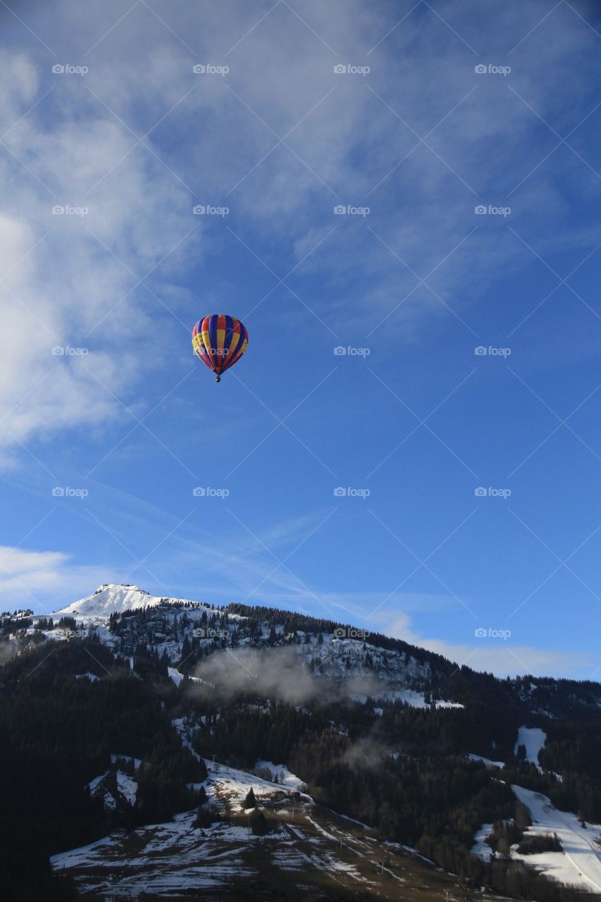 Hot air balloon over mountains