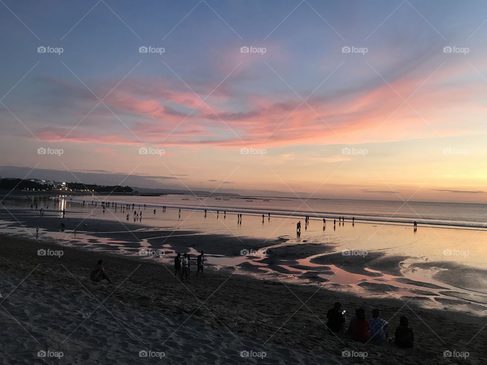 Sunset in Bali. The tide is out and the sea floor is soft.  This is nature at its finest and everyone wants to witness the magic