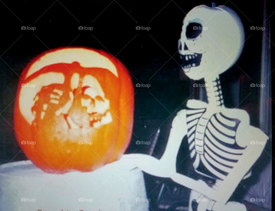 Halloween skeleton ☠ sitting next to hand carved 🎃 Grim Reaper Pumpkin, candle lit inside!
