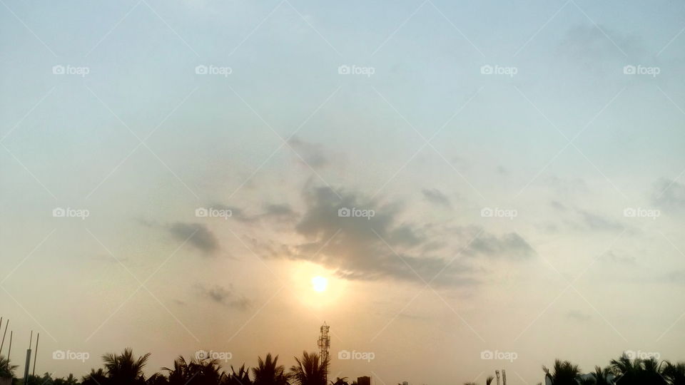 most beautiful sun rise seen,morning time,cloud magic with sun shine ,nature of morning ,tower seen in morning season,feel trees and plants at good morning