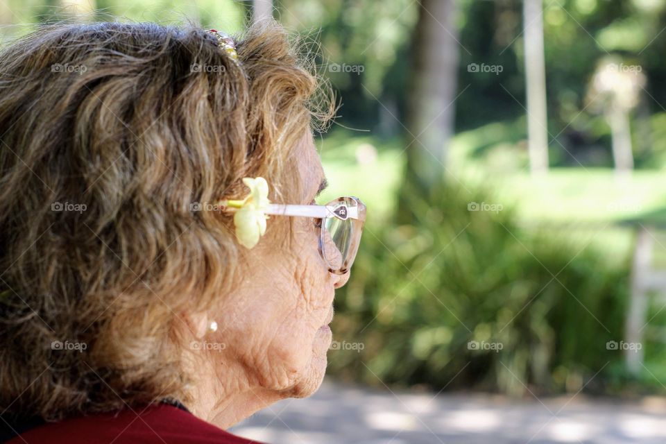 Elderly woman looking at nature in the park