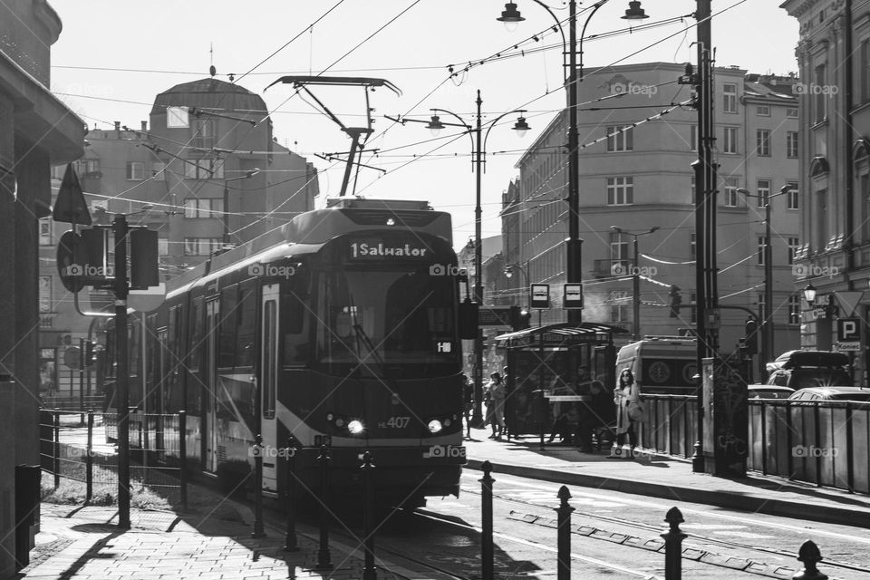 the tram leaves the stop during the morning rush hour