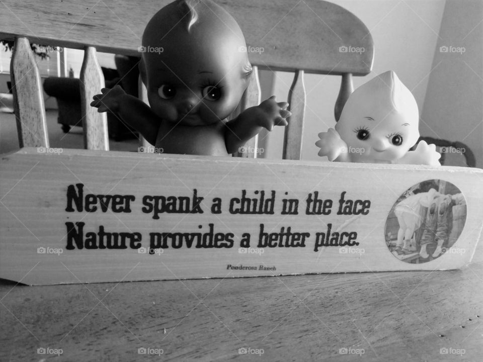 Kewpie dolls and children sign