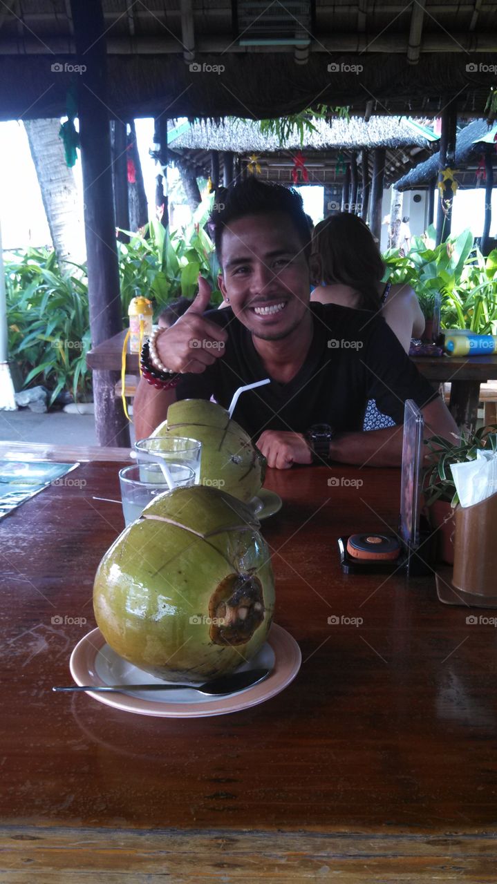 man with coconut drink