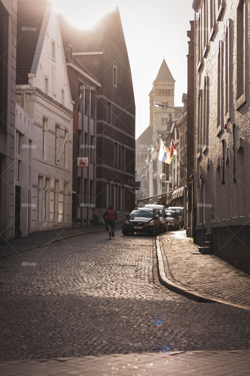 A portrait of a sunny cobblestone street in Maastricht in the Netherlands, the perfect place to go shopping.