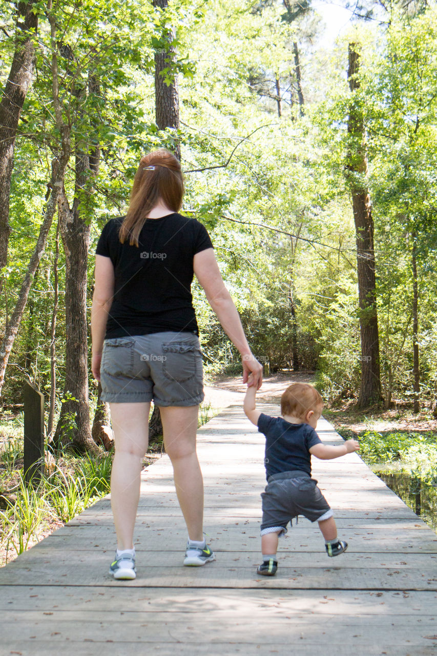 Mom and son walking in the park 