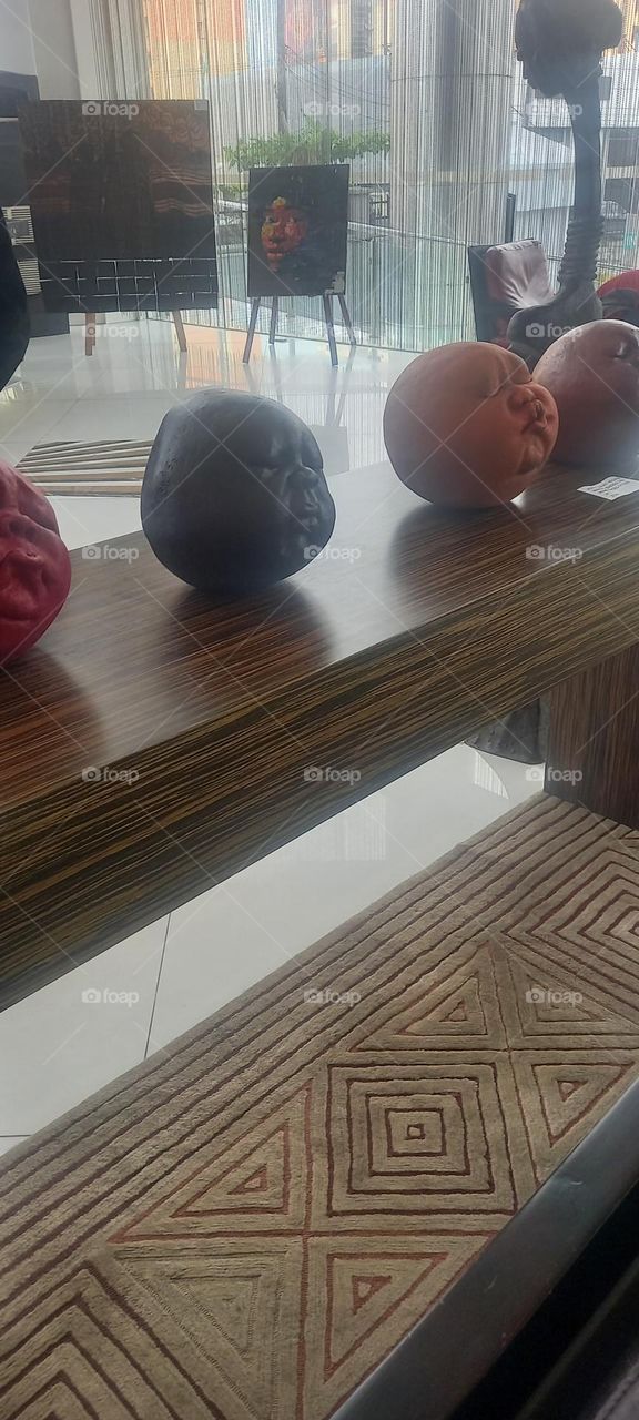 Awesome Art display of round clay faces with various expressions