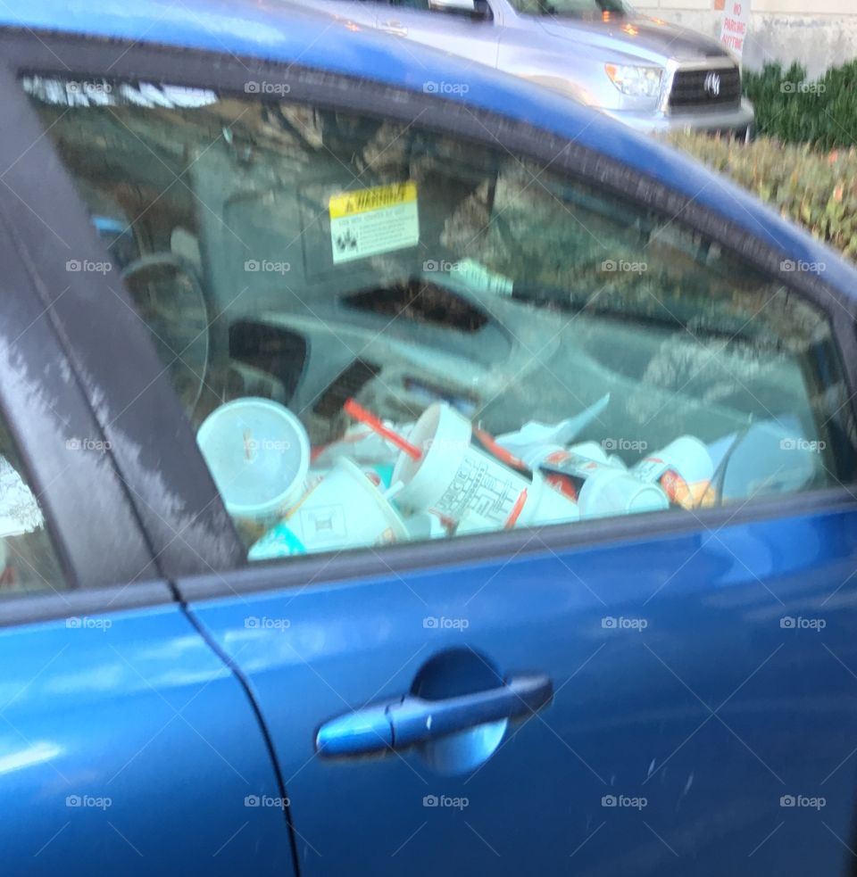 car in need of a trash can