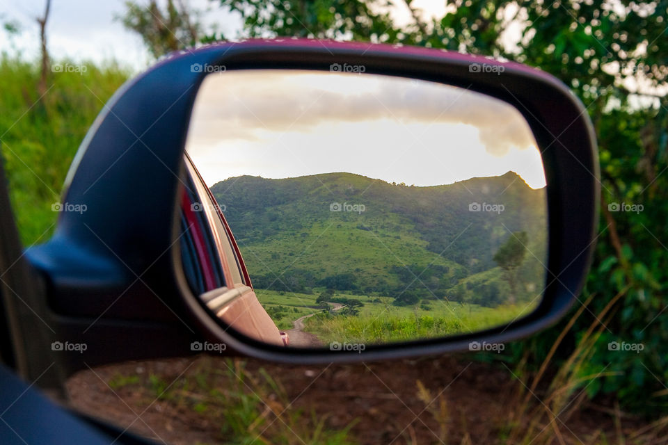 Reflections! I love the mystery of this image - wondering where the road will lead you. Image of mountain and pathway at sunset reflected in a car mirror.