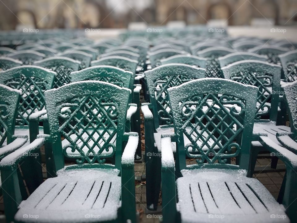 Snow on green chairs