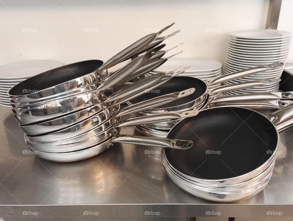 a stack of friing pans and plates