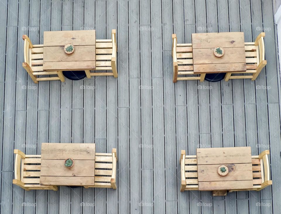 Wooden lunch tables from above.