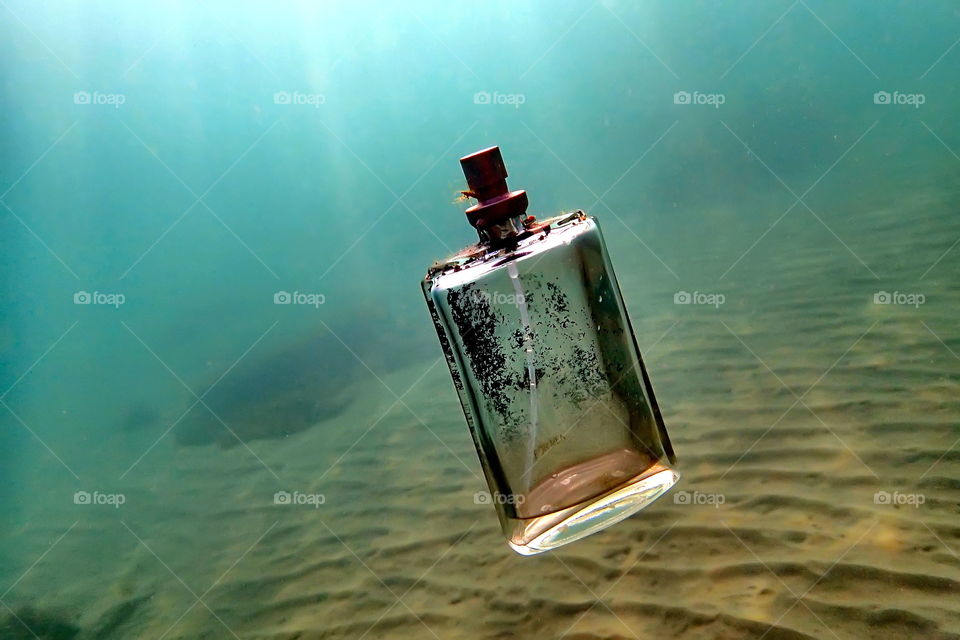 parfum bottle and sand