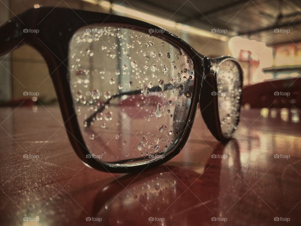 Spectacles after rain having water droplets.