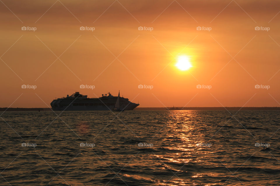 The sun princess departing Darwin at sunset