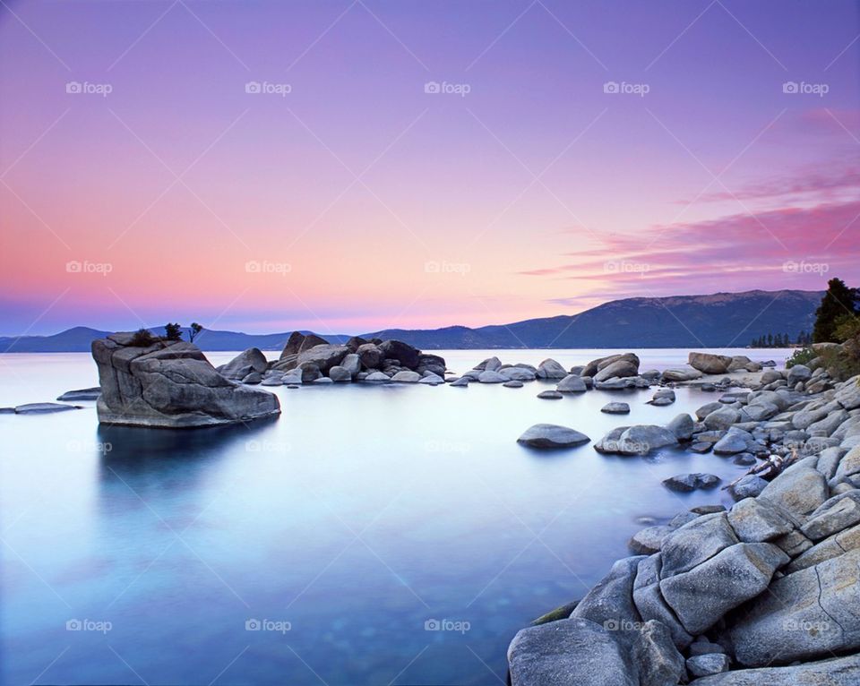 Stones in the sea during sunset