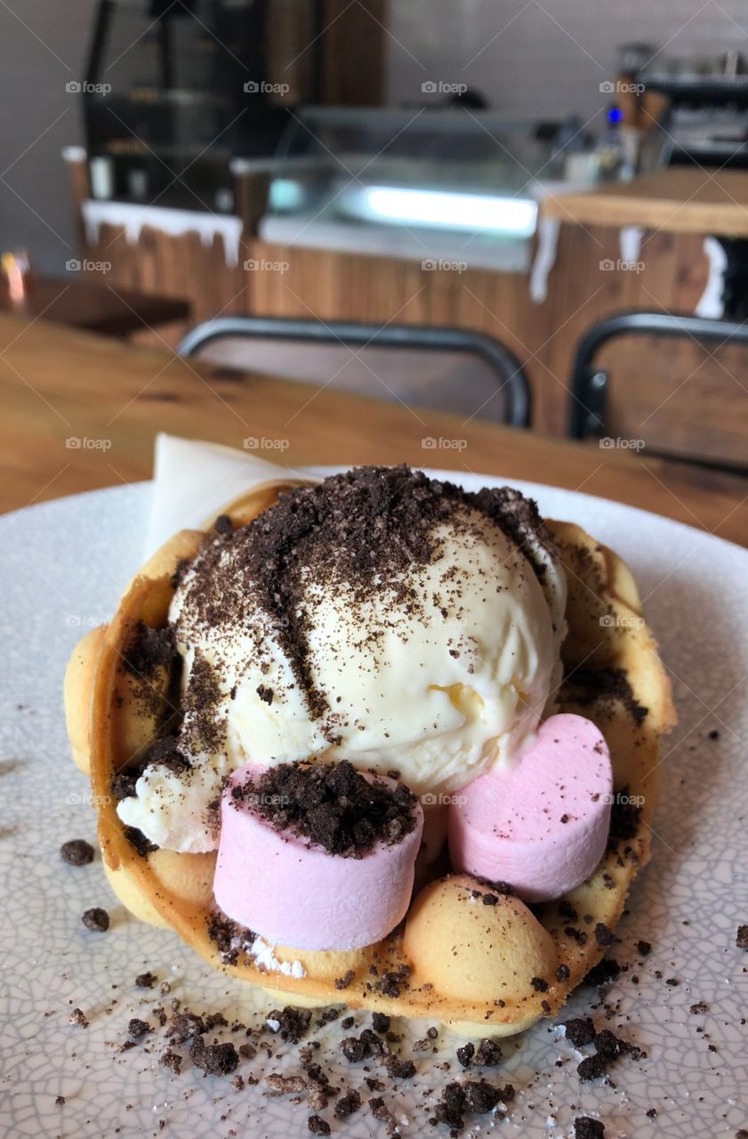 Bubble waffle cone with vanilla ice cream and strawberry marshmallows