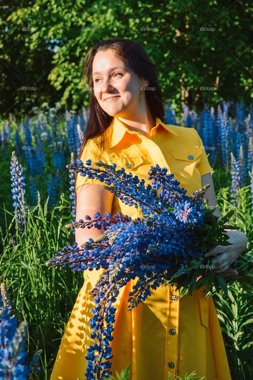 Woman with summer lupines 