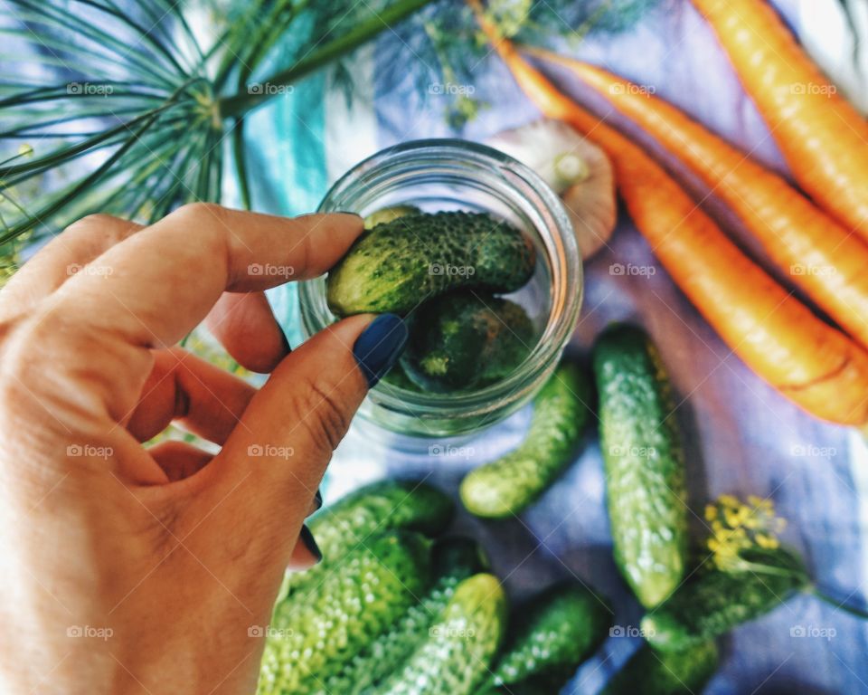 Close-up of hand holding cucumber